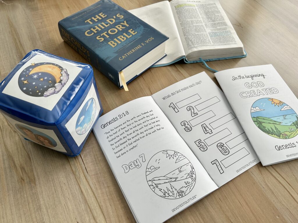 days of creation cube and book on table