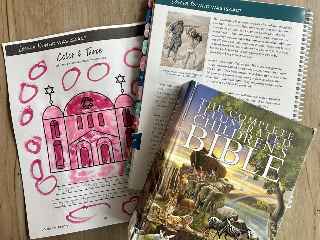 Children's illustrated Bible, Bible study and coloring page on table