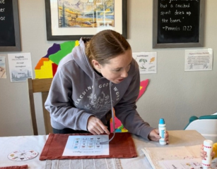 mom playing Japan four in a row game with spinner at kitchen table with daughter