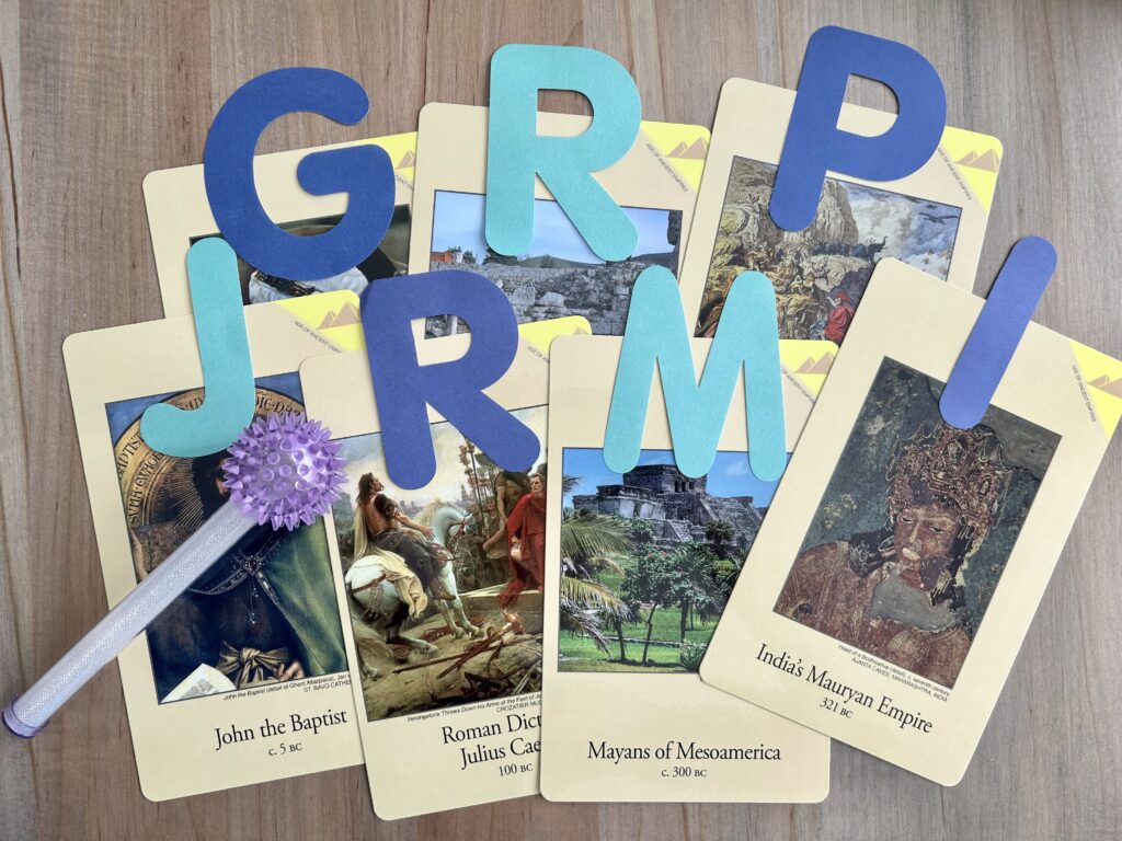 classical conversations timeline cards with large paper letters on them and light stick